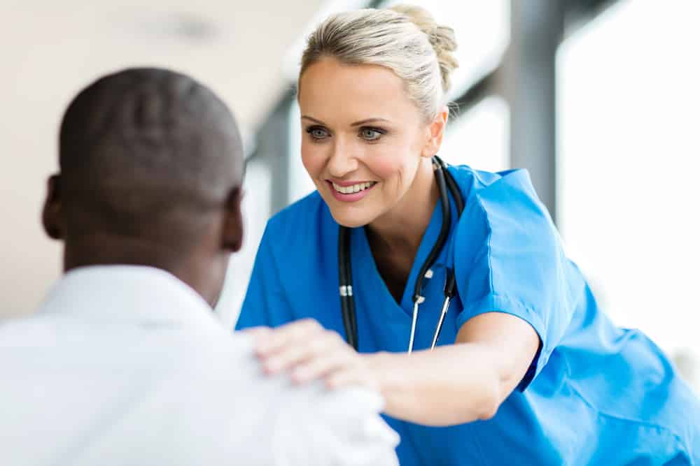 Clinical nurse talks to prostate cancer patient